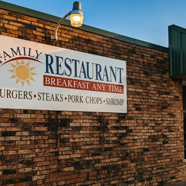D's Family Restaurant sign on a brick building, listing "Breakfast Any Time" and menu items.